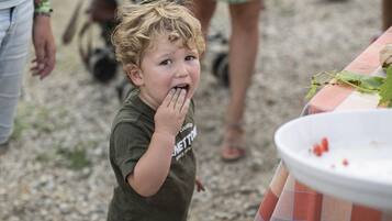 A child eating at an outdoor event.
