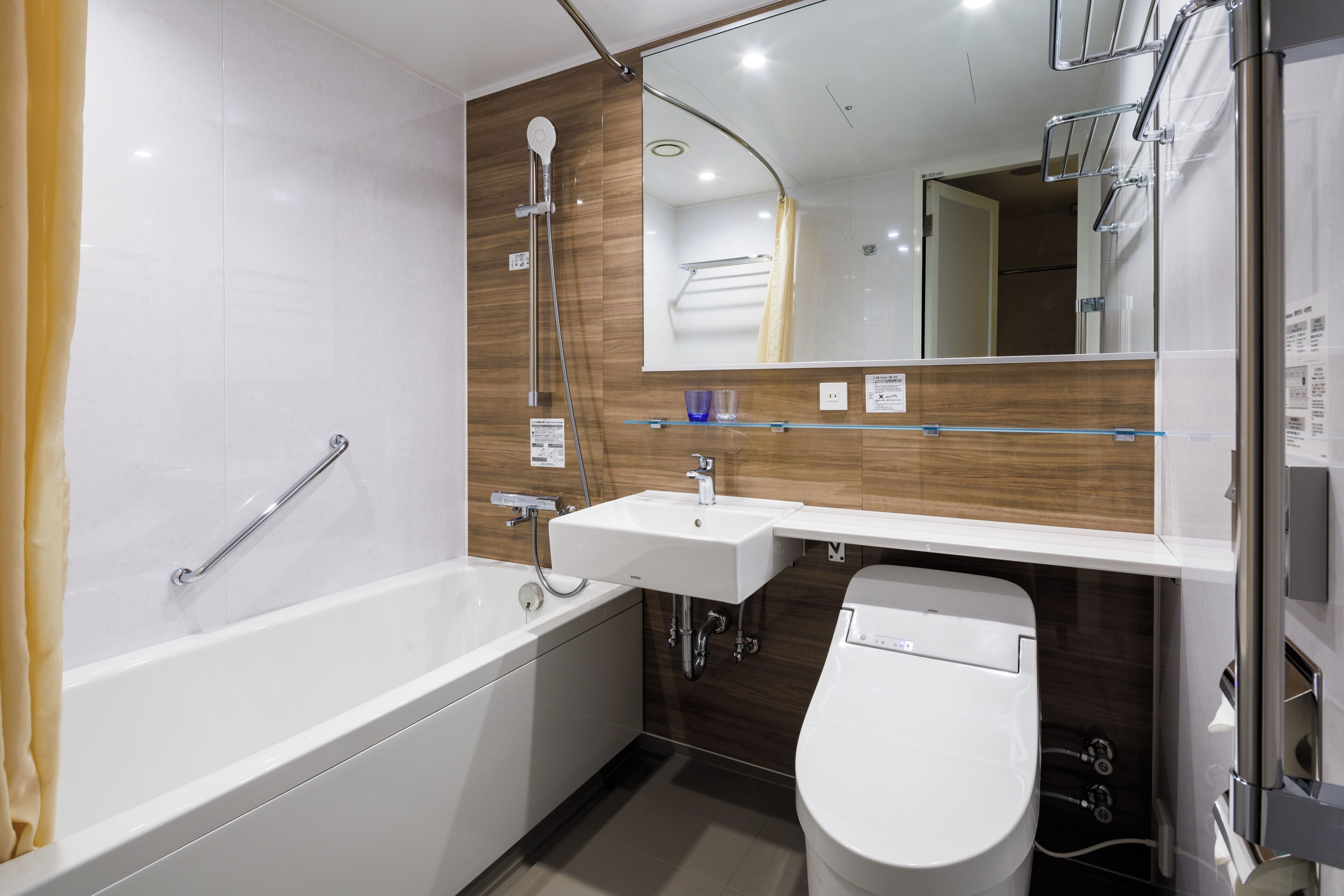 A modern bathroom with a bathtub, a sink, and a toilet.