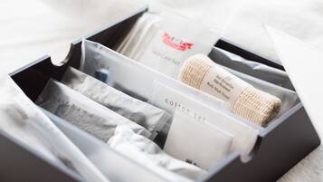 A black box containing various items including a hairband, cotton set, and a tissue.