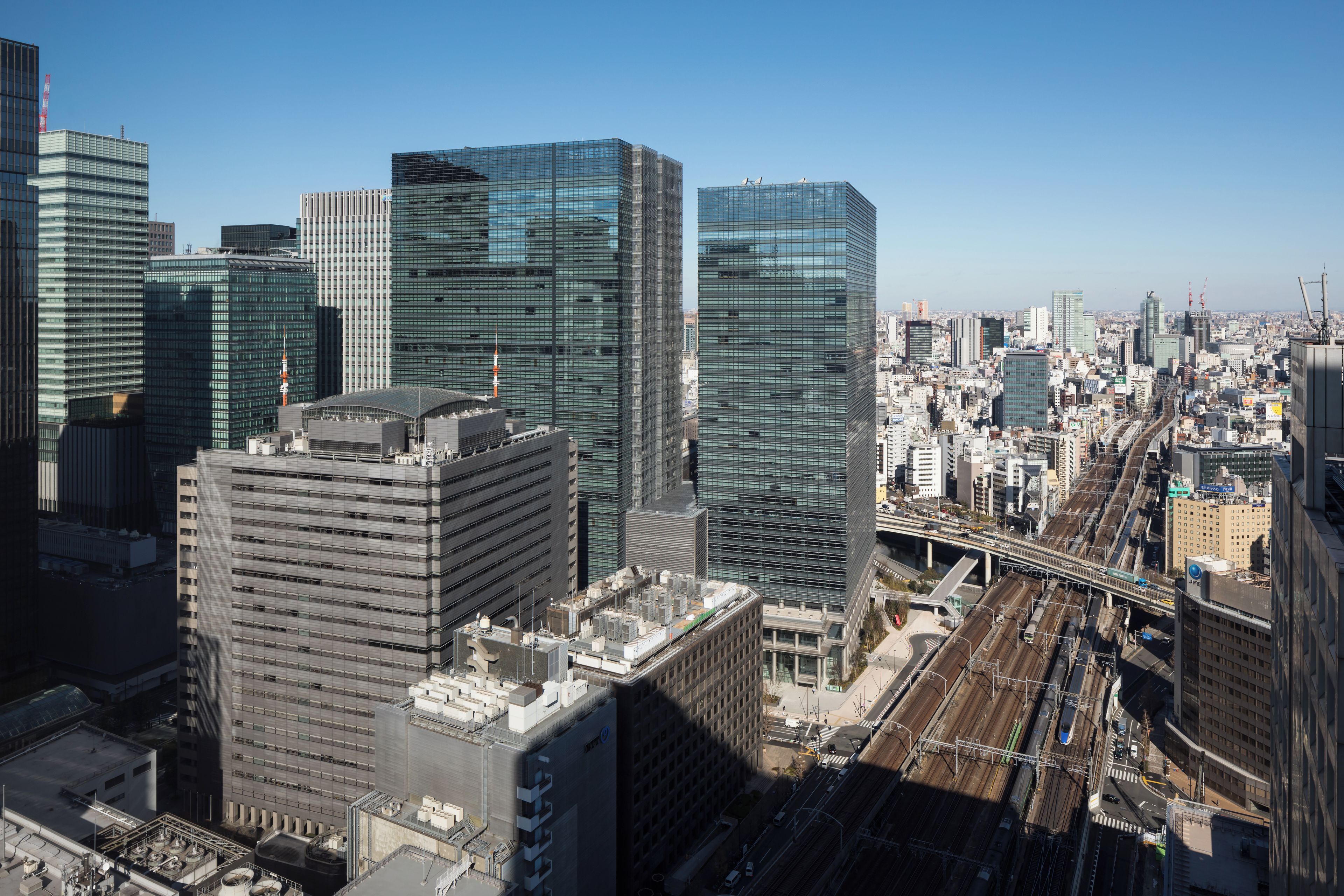 A high-rise urban area with modern architecture, including skyscrapers and a train station.