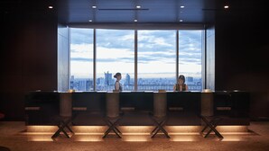 A reception area with a large window offering a city view. - Hotel Metropolitan Tokyo Marunouchi (Tokyo)