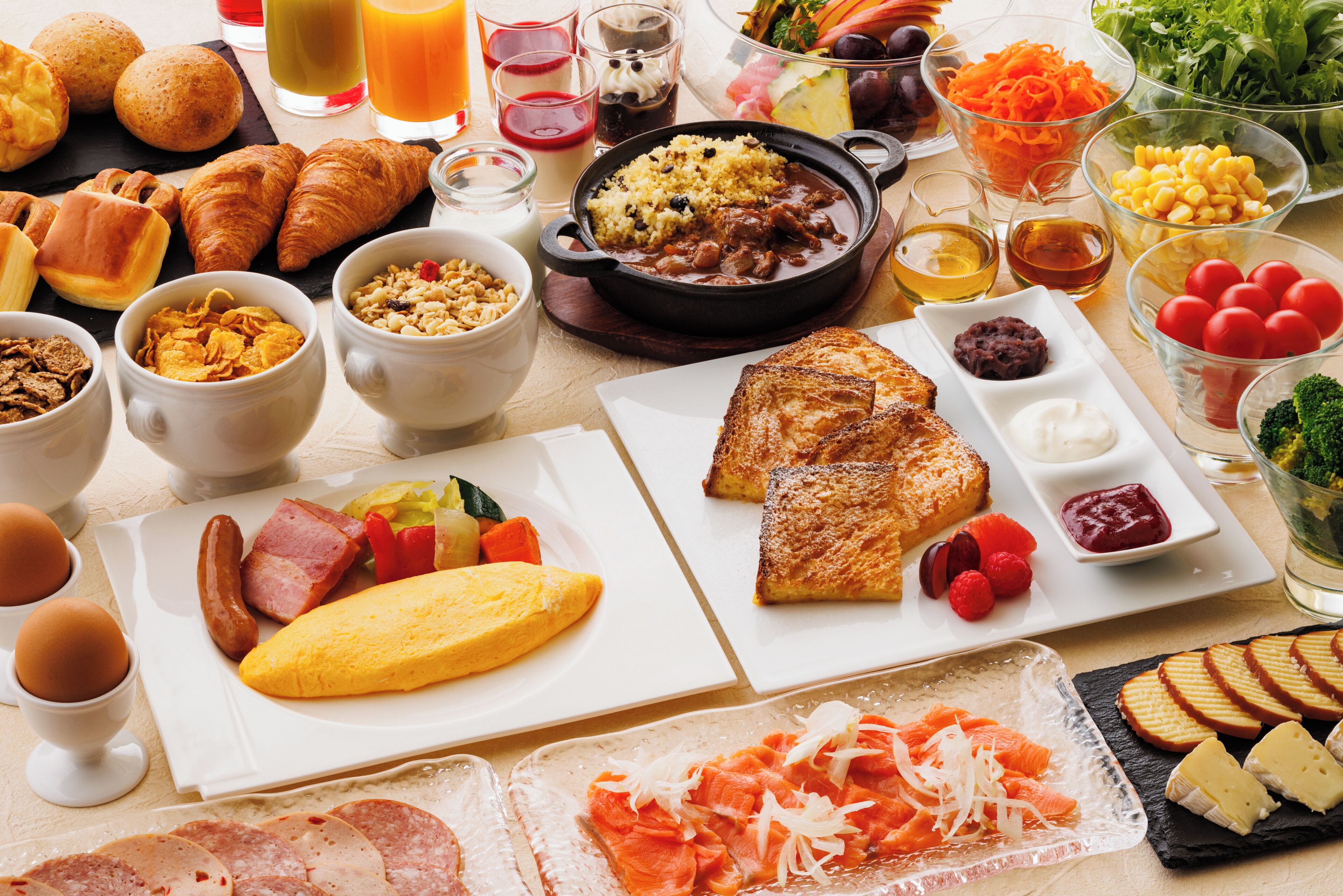A breakfast spread with various foods and drinks.