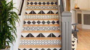 A staircase with patterned tiles and a potted plant. - The Landsby (Solvang)