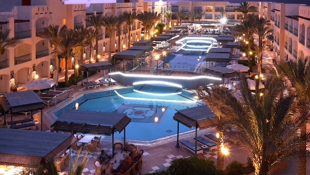 A resort with a swimming pool, lounge areas, and palm trees. - Bel Air Azur Resort - Adults Only (Hurghada)