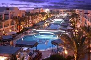 A resort with a swimming pool, lounge areas, and palm trees. - Bel Air Azur Resort - Adults Only (Hurghada)