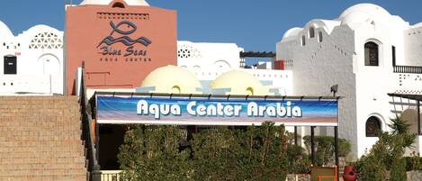 A building with a sign reading "Aqua Center Arabia" and a logo for "Blue Seas Aqua Center".