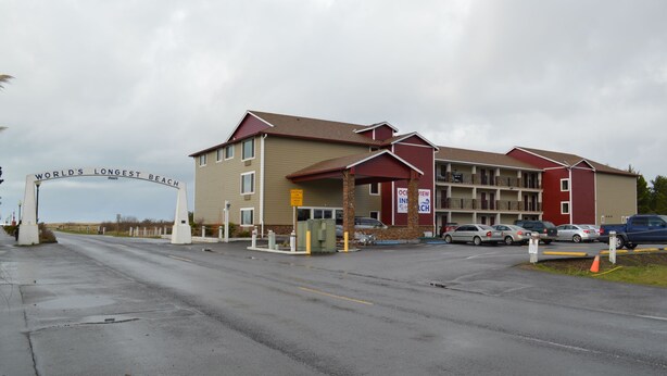 A multi-story motel with a prominent sign reading "WORLD'S LONGEST BEACH".