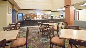A hotel dining area with multiple tables and chairs, a buffet counter, and a coffee station. - Holiday Inn Express & Suites Minot by IHG (Minot)