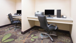 A hotel room with a desk, two monitors, a printer, and a chair. - Holiday Inn Express & Suites Minot by IHG (Minot)