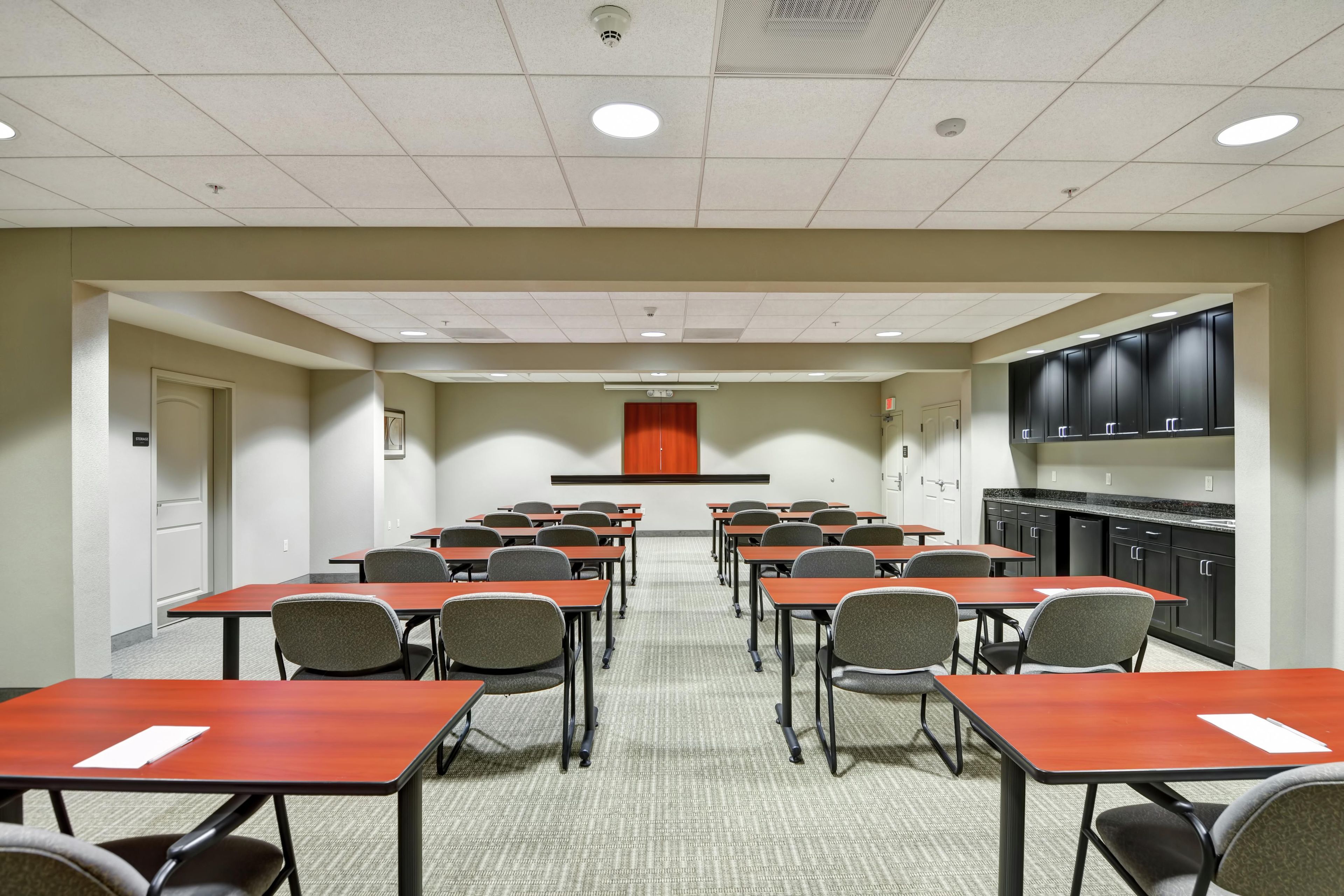 A conference room with tables and chairs arranged for meetings.