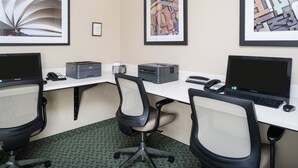 A modern office space with two desks, chairs, a printer, and framed artwork on the walls. - Candlewood Suites Olympia/Lacey by IHG (Lacey)