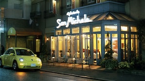 A restaurant named "San Michele" with outdoor seating and a yellow car parked in front. - Hotel Monterey La Soeur Ginza (Tokyo)