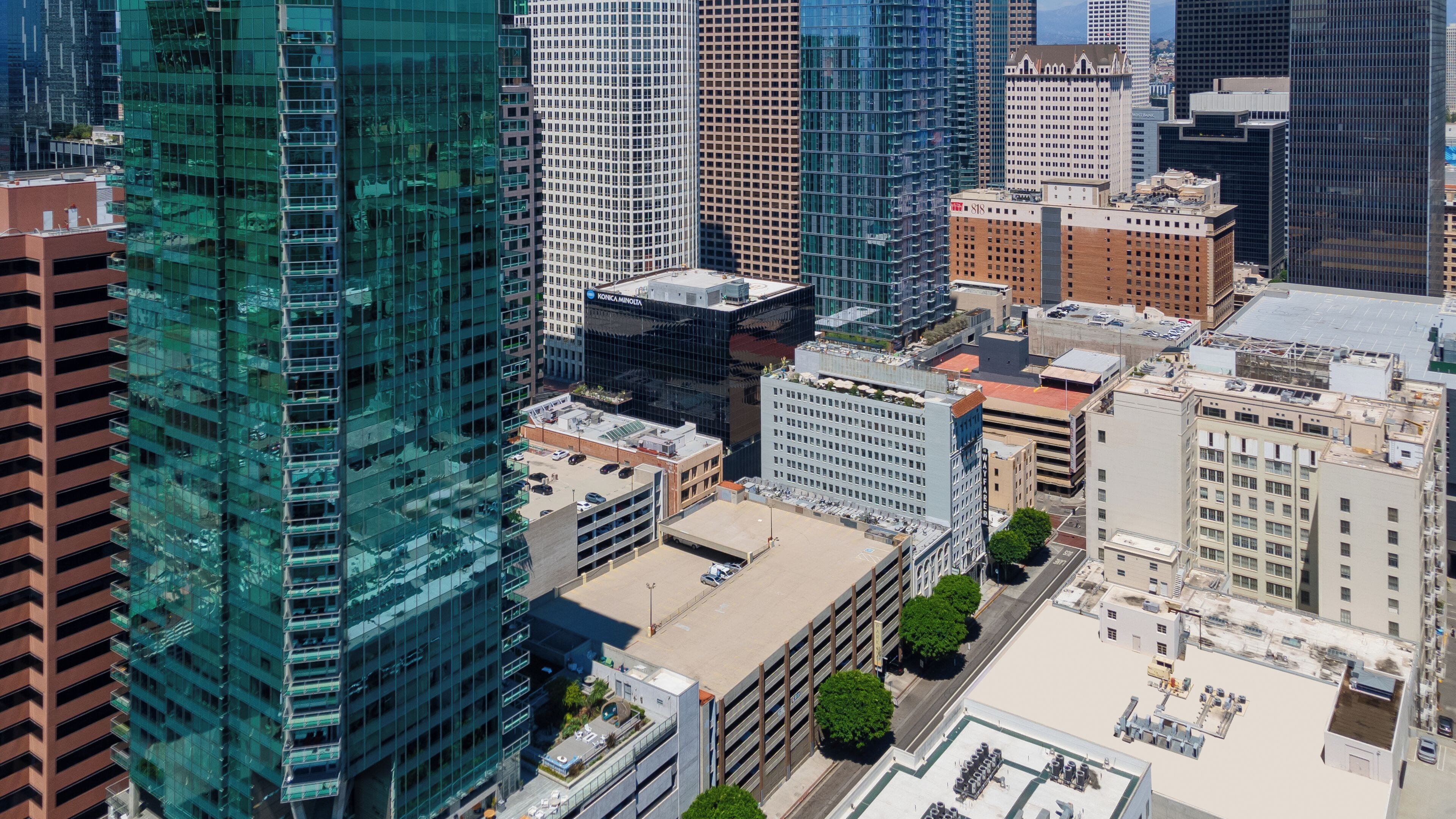 A high-rise building with a glass facade, surrounded by other tall buildings.