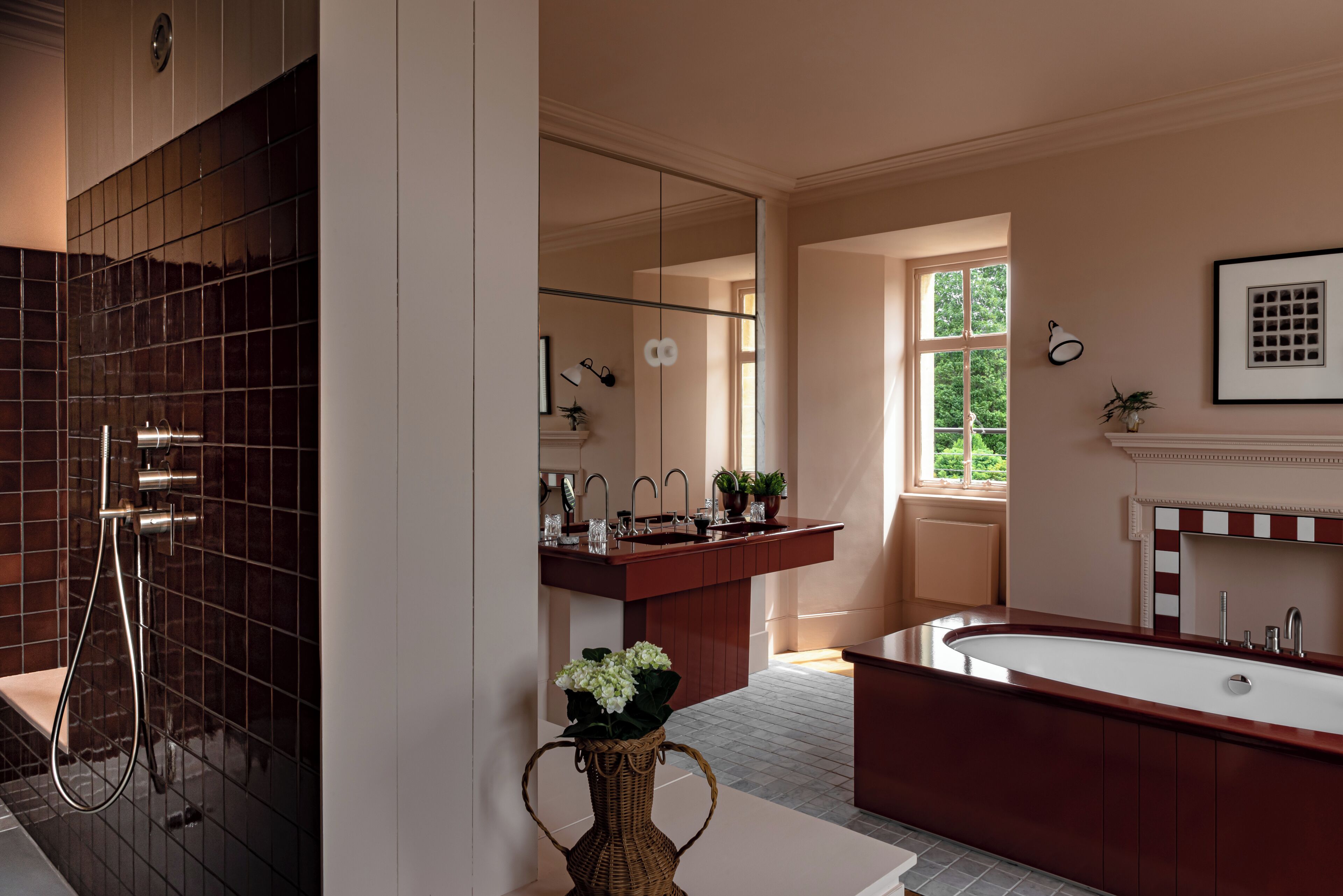 A modern bathroom with a large bathtub, a separate shower area, and a vanity with a mirror.