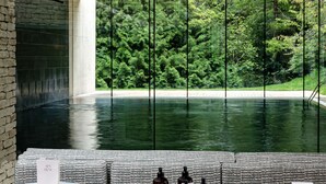 A spa area with a pool, seating, and a table displaying travel essentials. - Cowley Manor Experimental (Cheltenham)