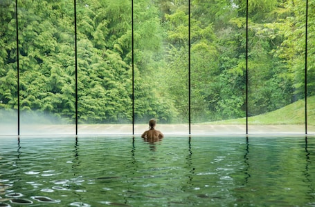 Indoor pool, outdoor pool, pool umbrellas, pool loungers. Cowley Manor Experimental