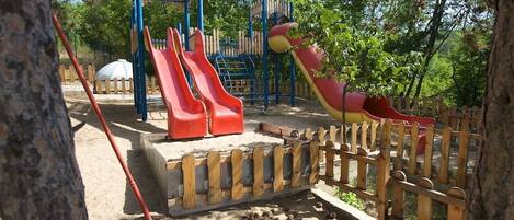 A playground with slides and climbing structures.