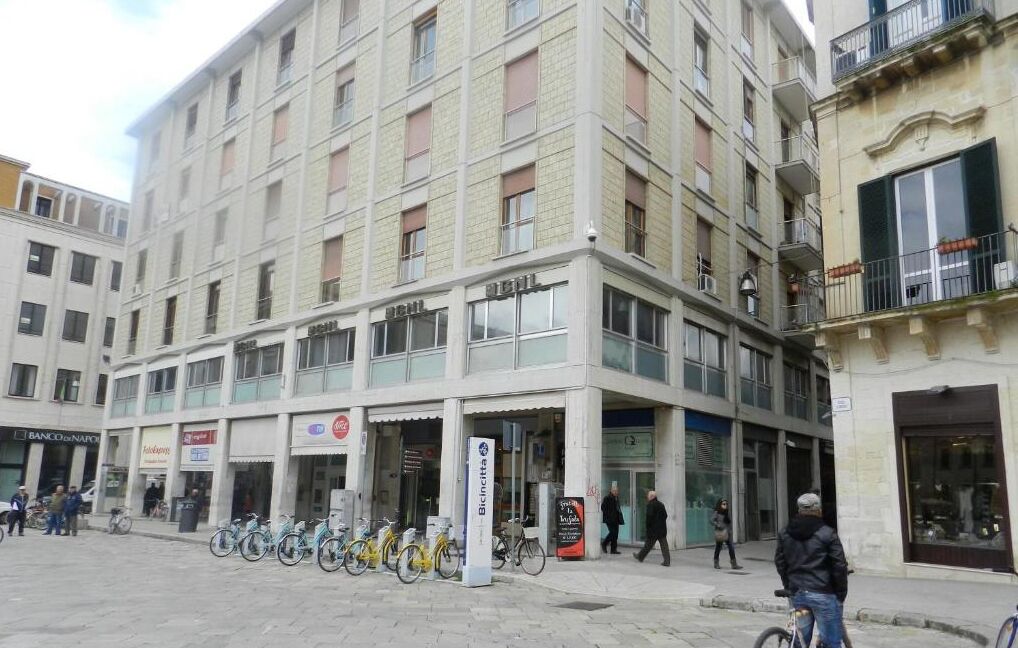 A multi-story building with a ground-floor retail space and upper residential or office units.