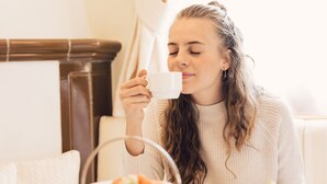 A person seated at a table with a teapot and cups, surrounded by various dishes and pastries. - Alpenpalace Luxury Hideaway & Spa Retreat (Valle Aurina)