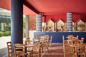 A lobby terrace with wooden tables and chairs, a bar area with shelves of bottles, and a sign reading "Lobby Terrace". -  Serena Majestic Hotel (Montesilvano)