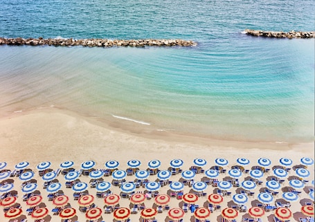 Private beach, sun loungers, beach umbrellas, windsurfing. Serena Majestic Hotel