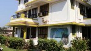 Un edificio de varios pisos con balcones y un letrero que dice "ALOR".
