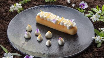 A dessert on a plate with flowers around it.