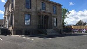 A two-story stone building with a symmetrical facade, large windows, and a central entrance with steps. - Scotia Airport Hotel (Paisley)