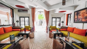 A hotel lobby with two sofas, a coffee table, and a patterned floor.