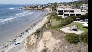 Une vue côtière comprenant une plage, l’océan et des immeubles résidentiels.