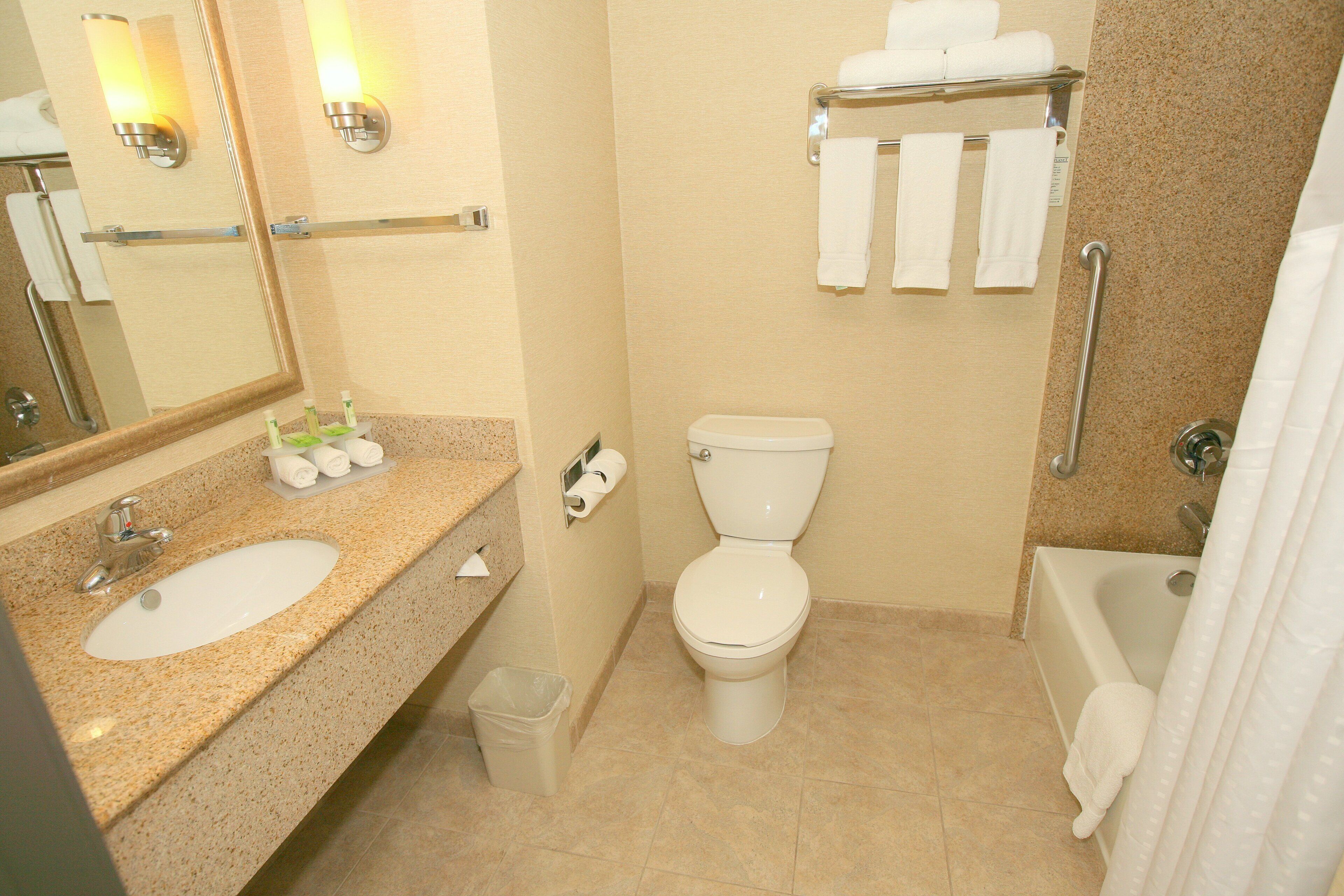 A bathroom with a sink, toilet, and bathtub.