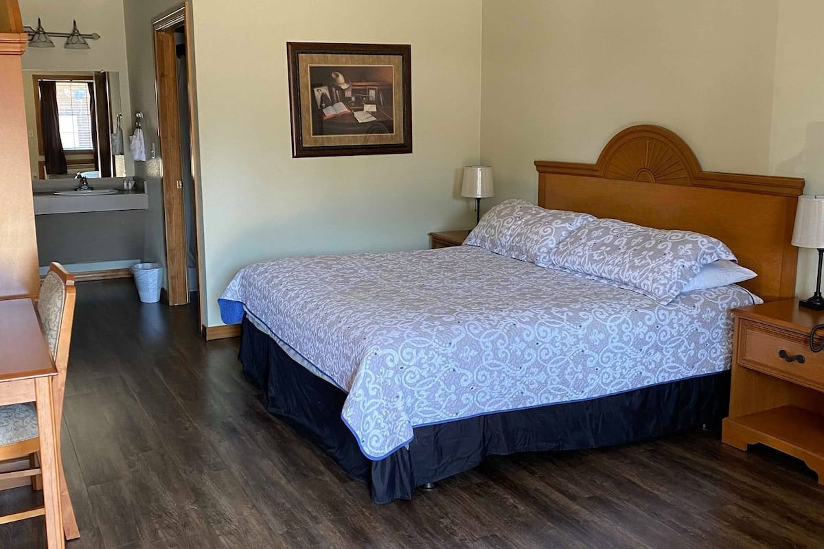 desk, iron/ironing board, bed sheets