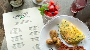 A menu titled "HERMANN HILL" with breakfast items like scrambled eggs and muffins.