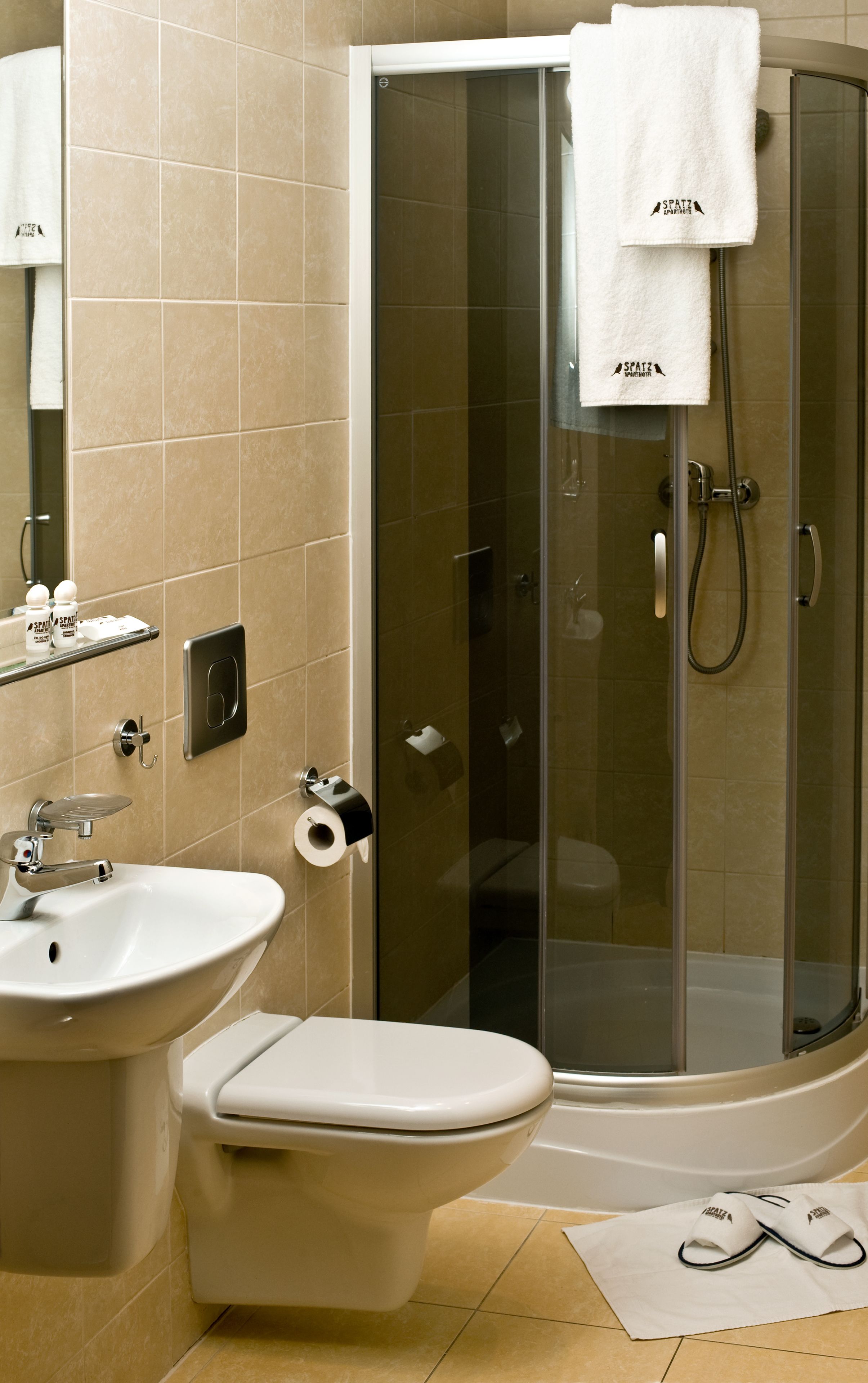 shower, hair dryer, towels, toilet paper