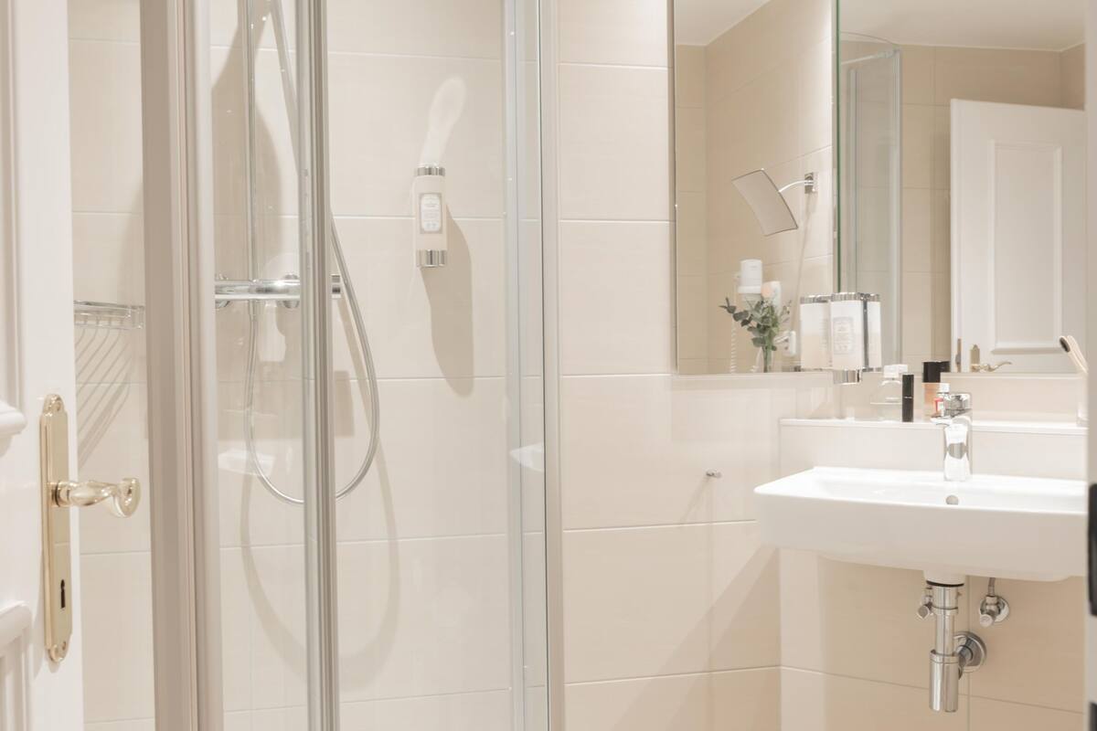 shower, hair dryer, towels, soap