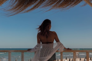 Deluxe Room, Sea View, Poolside | Minibar, in-room safe, blackout drapes, iron/ironing board
