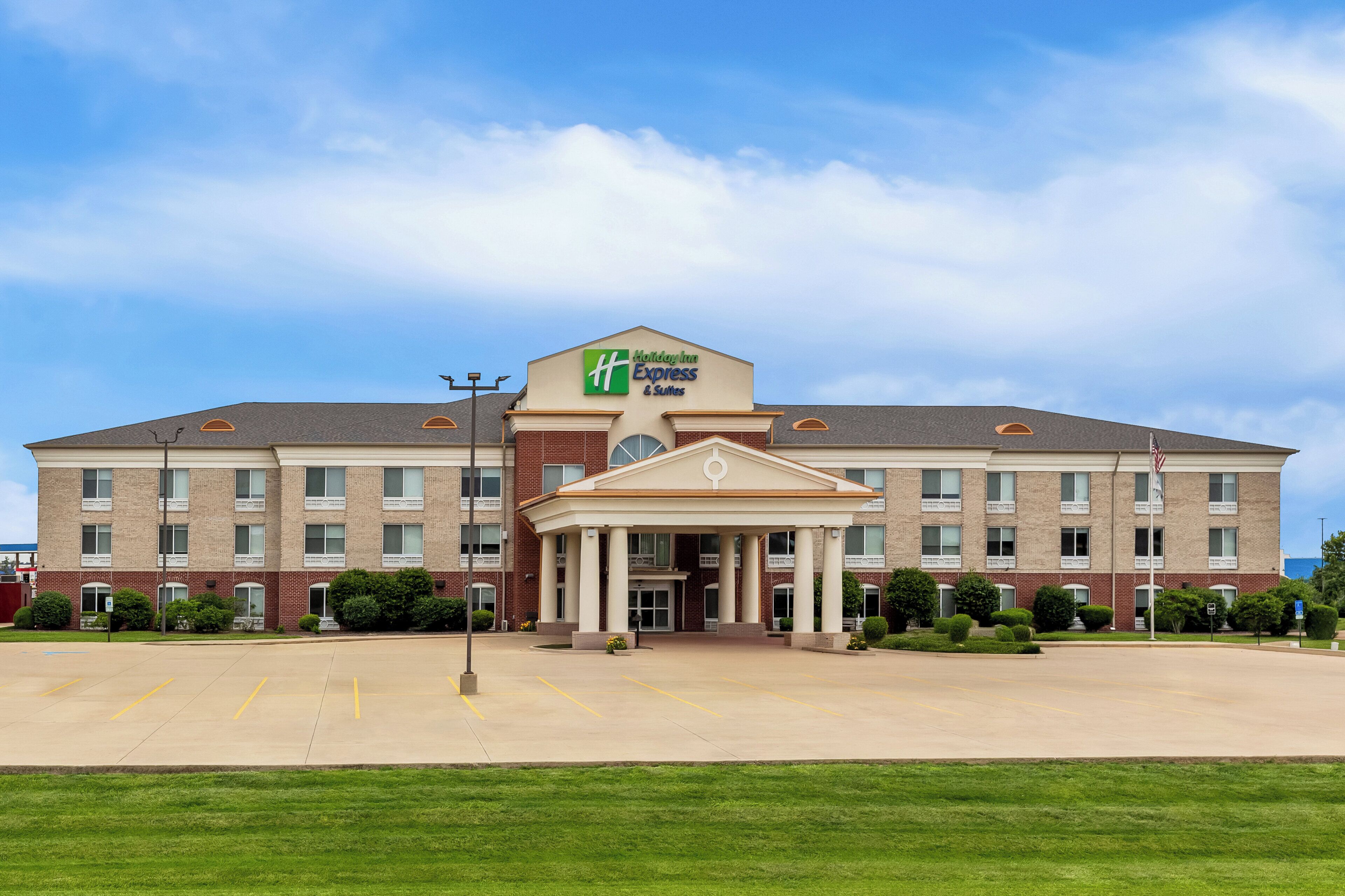 A Holiday Inn Express hotel with a central entrance, multiple windows, and a parking lot.