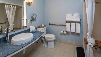 A bathroom with a sink, toilet, and shower.