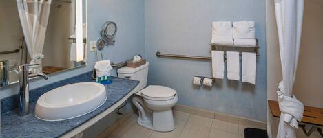 A bathroom with a sink, toilet, and shower.
