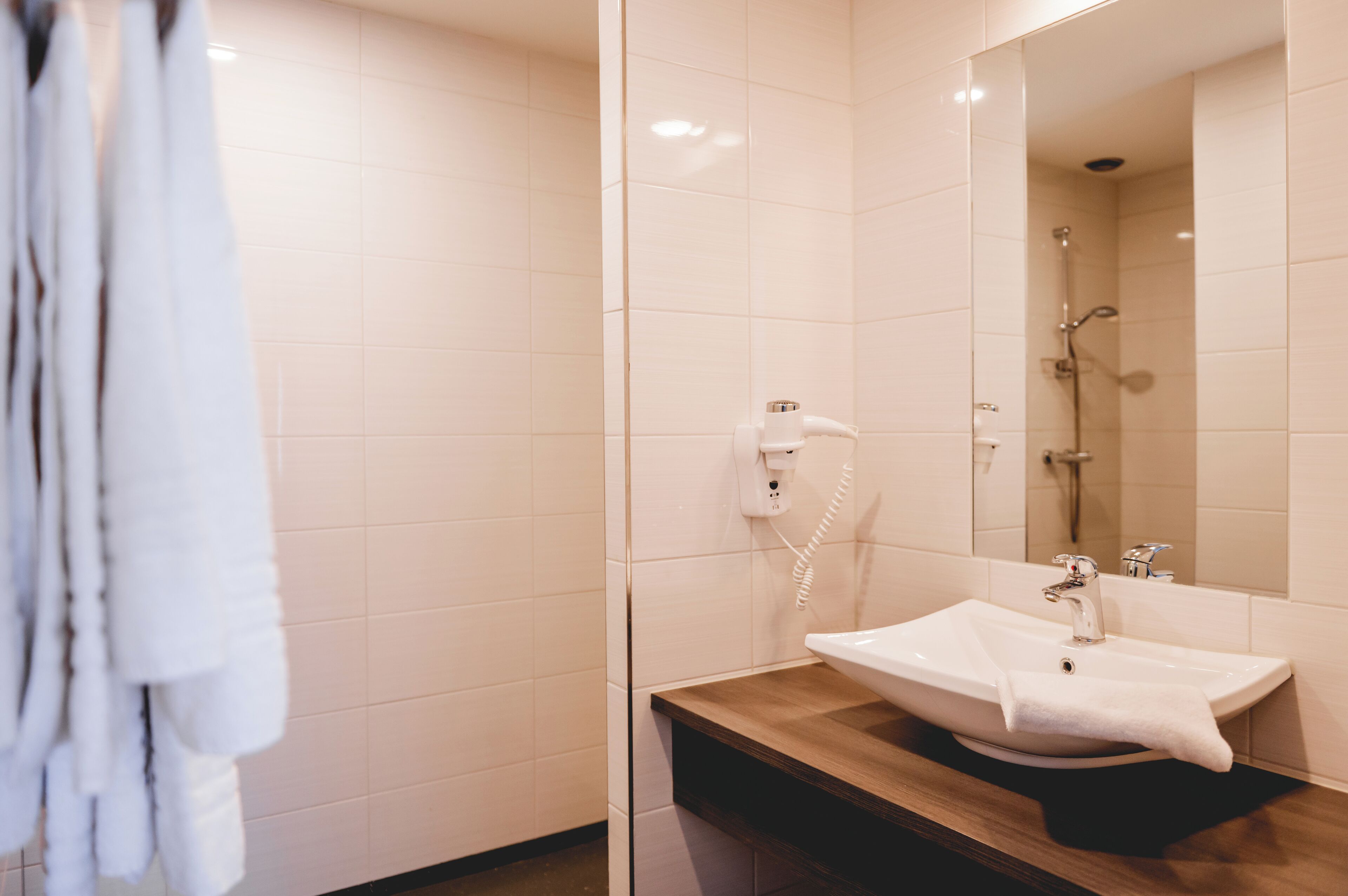 shower, rainfall showerhead, hair dryer, towels