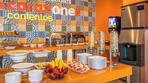 A breakfast buffet with various food items and a coffee station. - One Monterrey Aeropuerto (Apodaca)