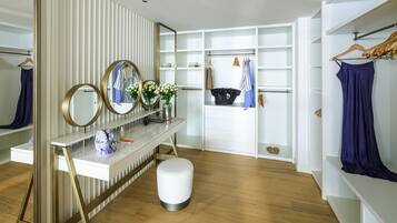 A modern vanity with mirrors, a vase of flowers, and a handbag.