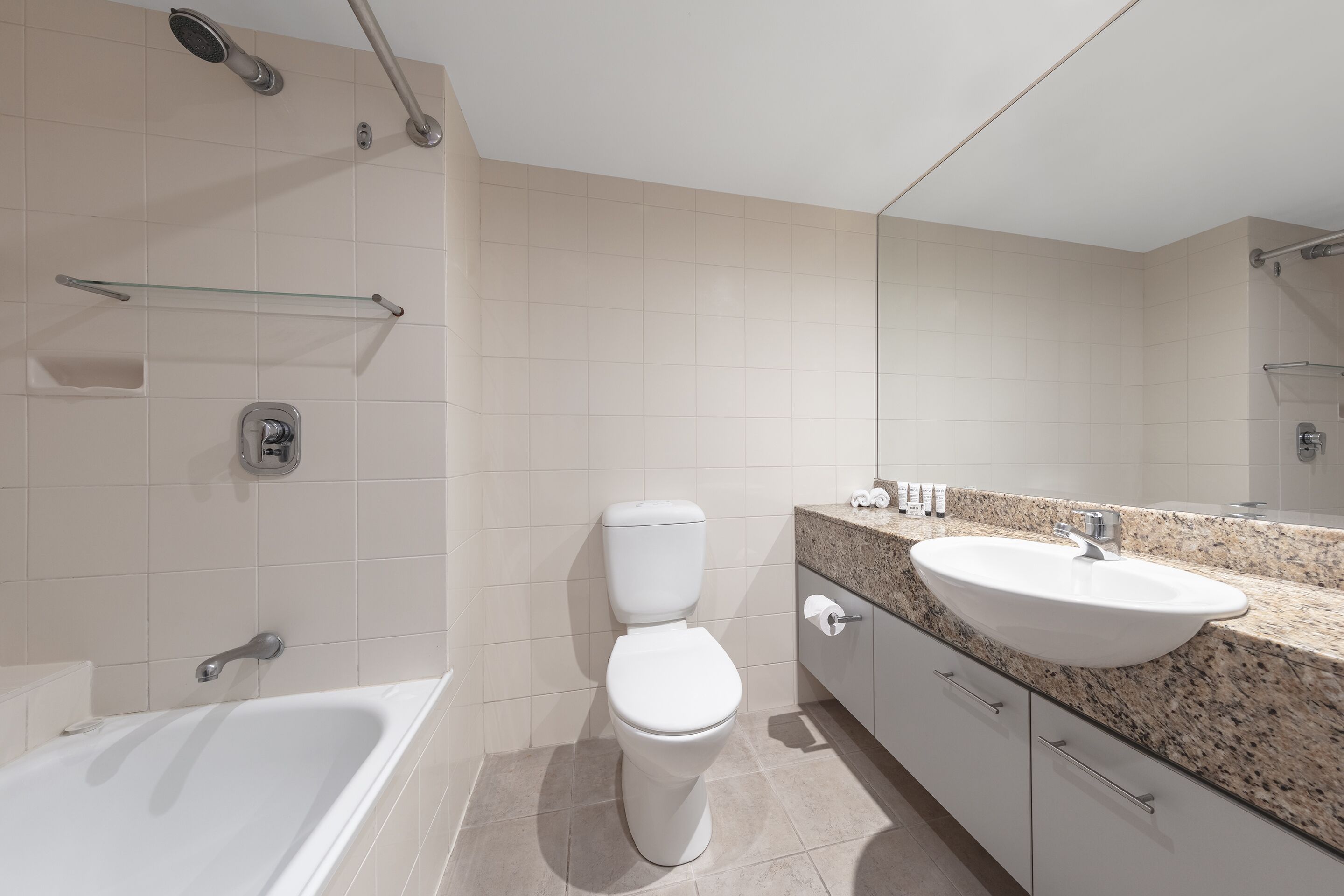 A modern bathroom with a bathtub, toilet, and sink.
