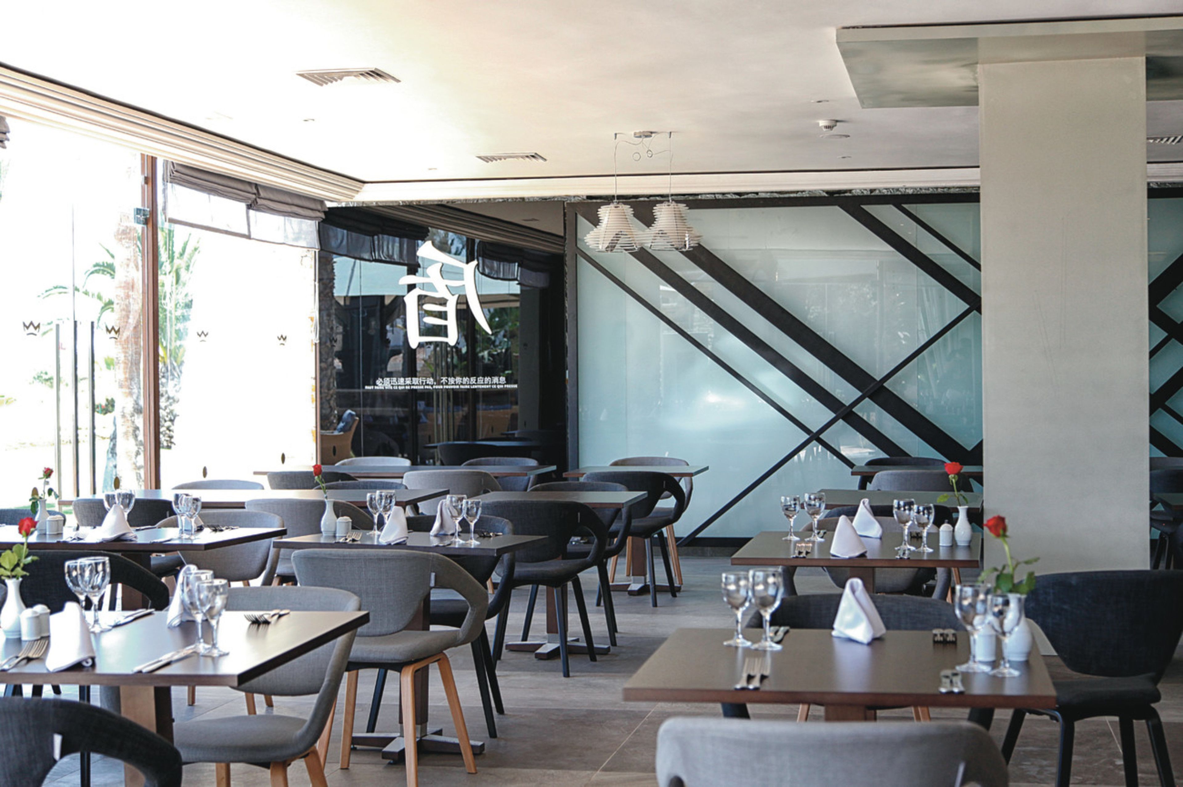 A restaurant with tables and chairs arranged for dining.