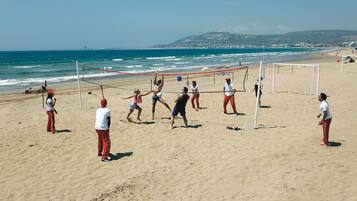 Sun loungers, beach umbrellas, beach volleyball