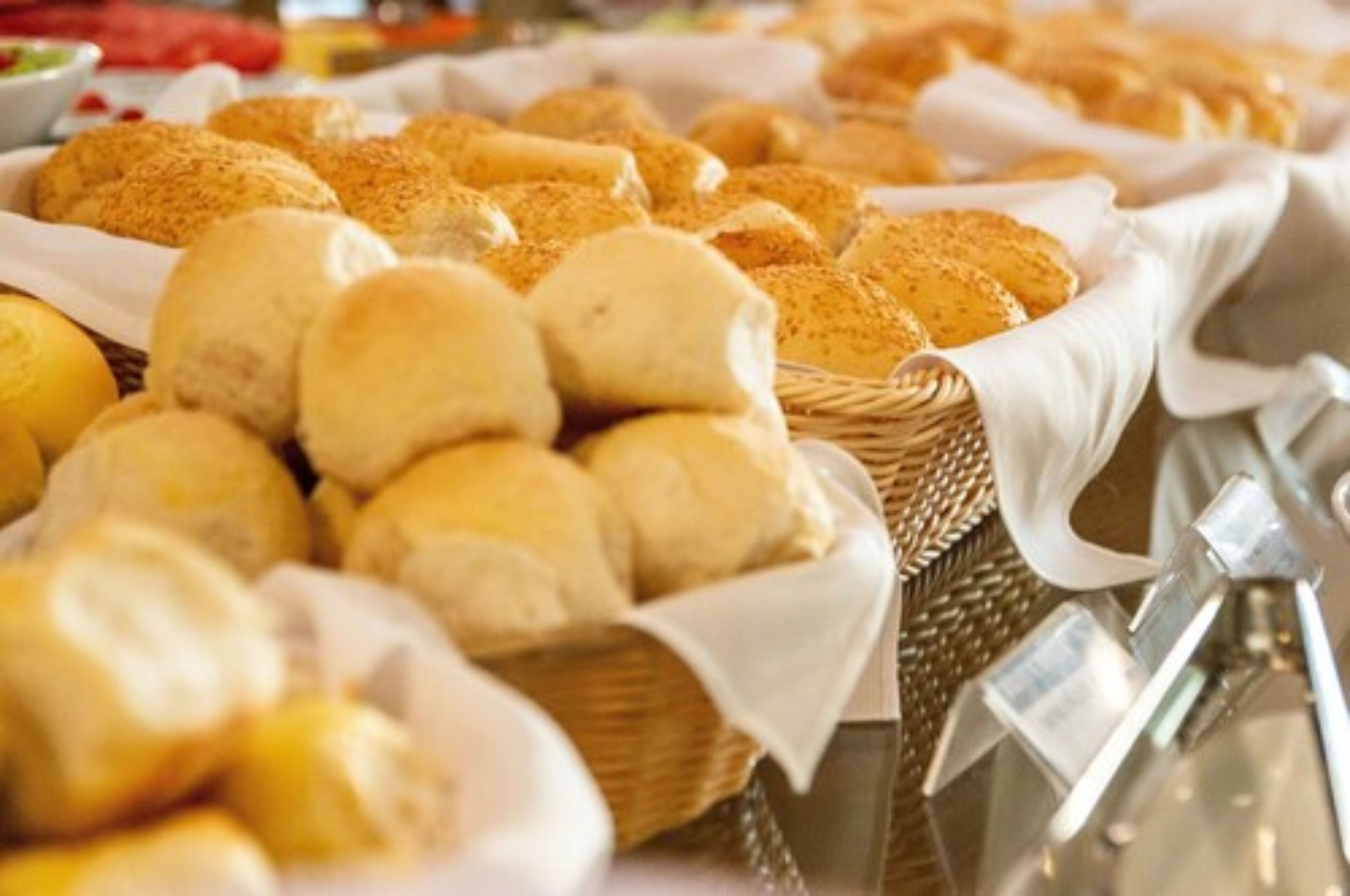 A variety of bread and pastries displayed in baskets.