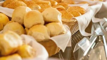 A variety of bread and pastries displayed in baskets.