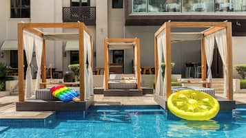Una piscina al aire libre, sillones reclinables de piscina