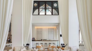 A spacious lobby with high ceilings, large windows, and a modern interior design. - Hotel Boulevard, Autograph Collection (Dubai)