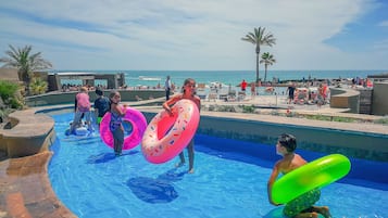 Relax by the pool or on the adjacent beach, where lounge chairs and umbrellas await.